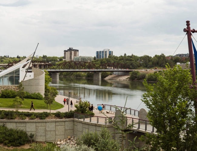 Individuals walking by the river in downtown saskatoon
