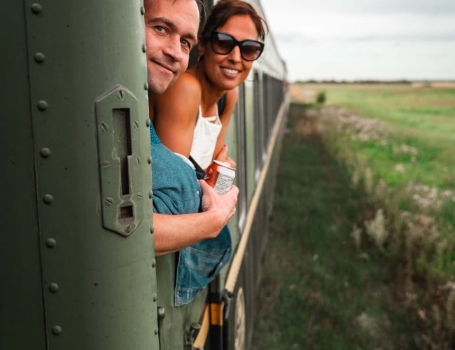 A couple looking out the window of a train