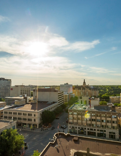 Aerial view of the city of Saskatoon with a blue sky and buidings