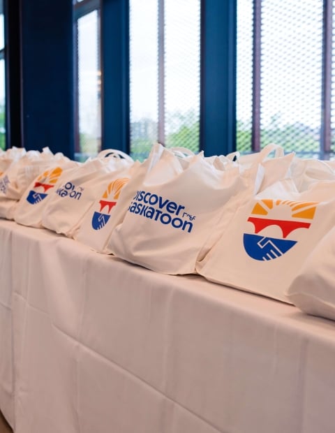 Discover Saskatoon branded bags on a table